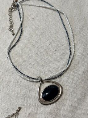 Elegant Silver Pendant Necklace with Black Stone and White Beaded Strands
